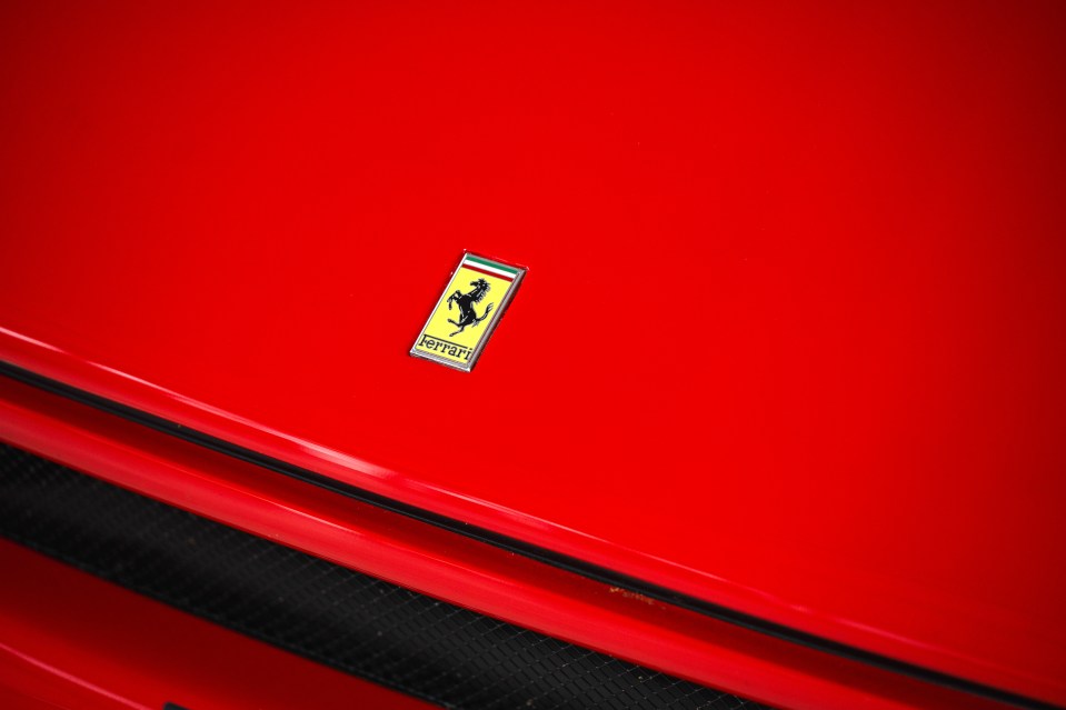 Ferrari logo on a red car hood.