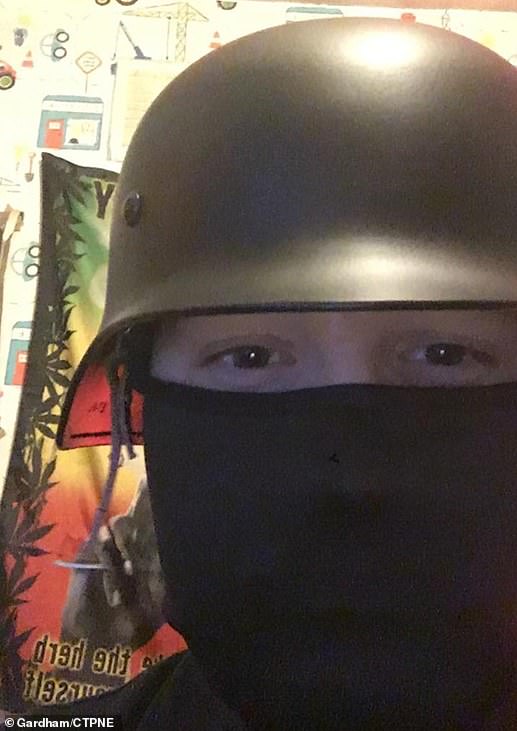 Self-styled 'stay at home domestic terrorist' Brogan Stewart wearing a Nazi helmet in his childhood bedroom