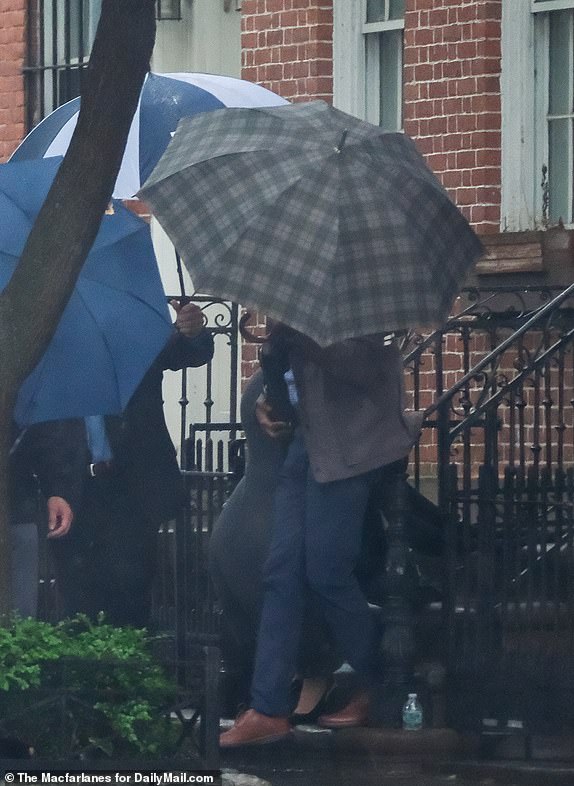 May 14th, 2025Cassie Venture is seen surrounded by umbrellas as she leaves to court for the Diddy case in NYC