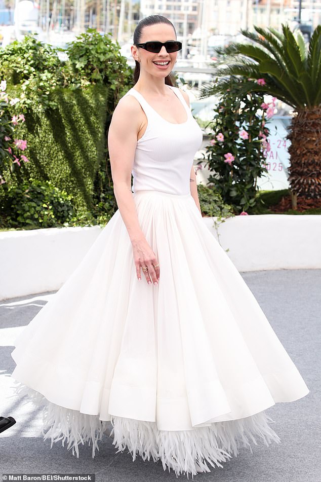 Hayley pulled out all the stops for the morning sunshine wowing in a feather-trimmed full white skirt at the photocall earlier in the day