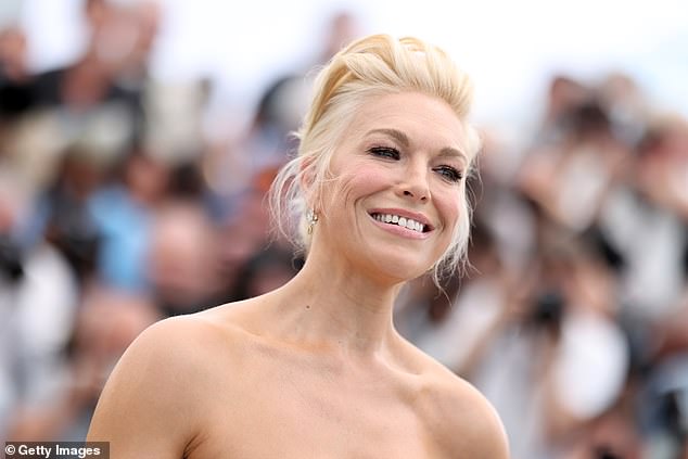 The Ted Lasso star flaunted her Cannes tan as she happily posed with the all-star cast