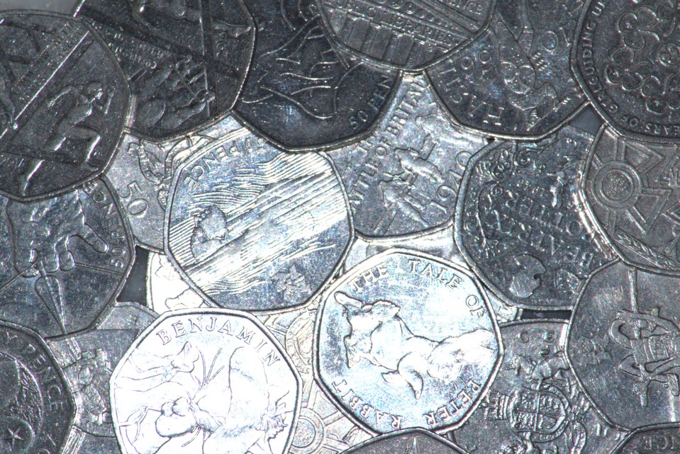 Pile of UK fifty pence coins.