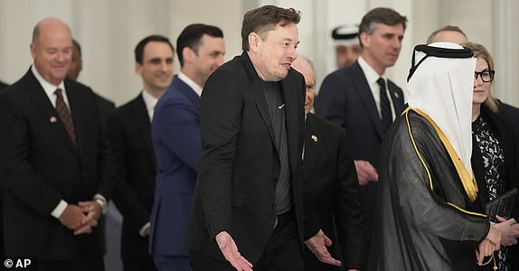 Elon Musk gestures as he arrives for a state dinner hosted by Qatar's Emir Sheikh Tamim bin Hamad Al Thani in honor of President Donald Trump at Lusail Palace in Doha, Qatar, Wednesday, May 14, 2025. (AP Photo/Alex Brandon)