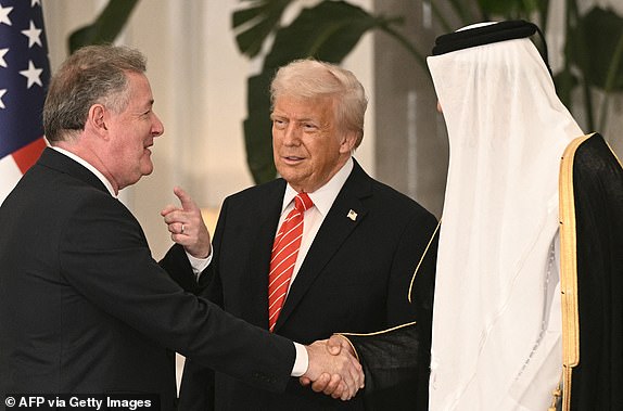 Qatar's Emir Sheikh Tamim bin Hamad al-Thani (R) and US President Donald Trump (C) greet British journalist Piers Morgan ahead of a state dinner at the Lusail Palace in Doha on May 14, 2025. (Photo by Brendan SMIALOWSKI / AFP) (Photo by BRENDAN SMIALOWSKI/AFP via Getty Images)