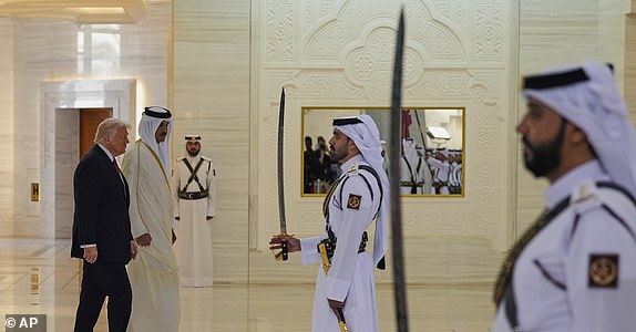 Qatar's Emir Sheikh Tamim bin Hamad Al Thani welcomes President Donald Trump during an official welcoming ceremony at the Amiri Diwan in Doha, Qatar, Wednesday, May 14, 2025. (AP Photo/Alex Brandon)