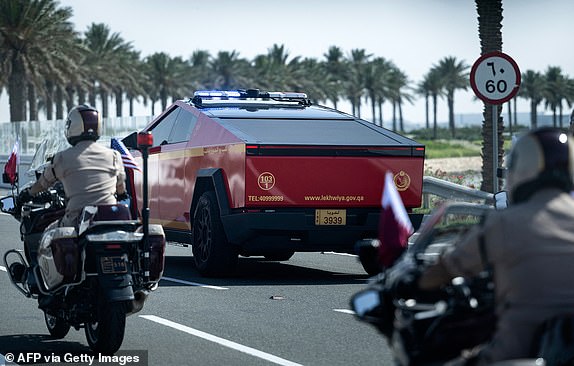 A Qatari police Tesla Cyber Truck escorts the motorcade of US President Donald Trump from Hamad International Airport toward the Royal Palace in Doha on May 14, 2025. Trump touched down at Hamad International Airport in Doha, with relations between the two governments in the spotlight over Qatar's offer to Trump of a $400 million luxury aircraft to serve as a new Air Force One and then pass into his personal use. (Photo by Brendan Smialowski / AFP) (Photo by BRENDAN SMIALOWSKI/AFP via Getty Images)