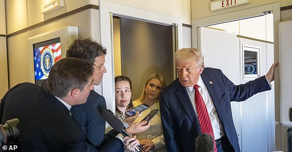 President Donald Trump speaks to reporters aboard Air Force One en route from Riyadh, Saudi Arabia to Doha, Qatar, Wednesday, May 14, 2025. (AP Photo/Alex Brandon)