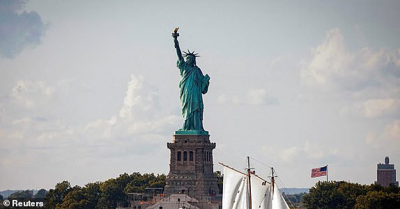 FILE PHOTO: A sailboat passes by the Statue of Liberty in New York Harbor, in New York City, U.S., September 20, 2024.  REUTERS/Brendan McDermid/File Photo