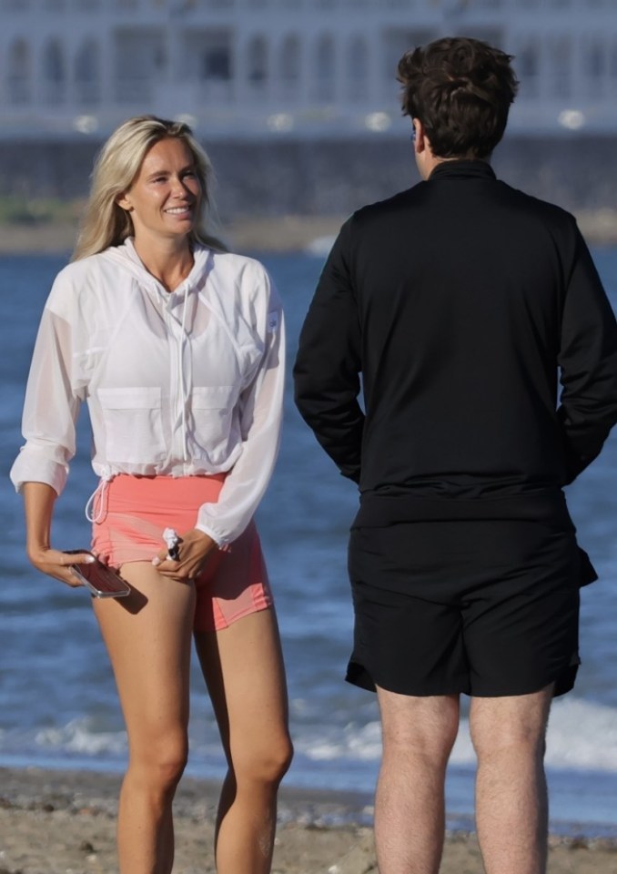 James Argent and Nicoline Artursson on a beach.