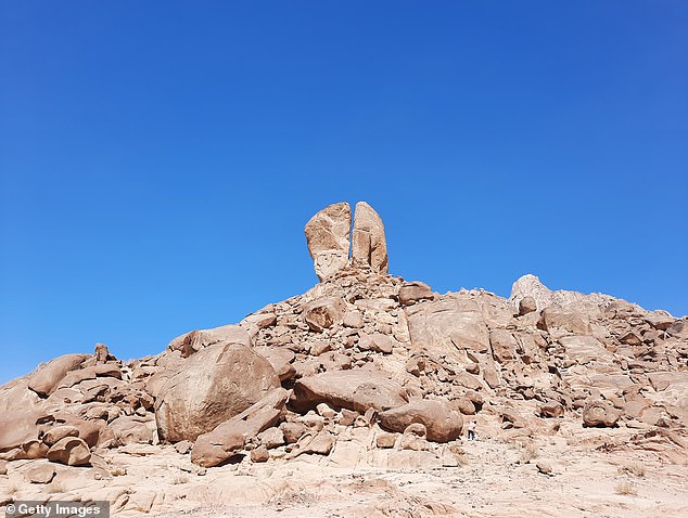 Another clue is the 'Split Rock' near the mountain, which would align with the Biblical story that Moses struck a rock at Horeb to provide water for the Israelites, who were thirsty and complaining
