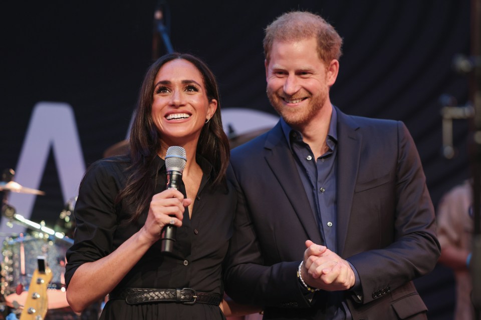 Prince Harry and Meghan Markle speaking on stage at the Invictus Games.