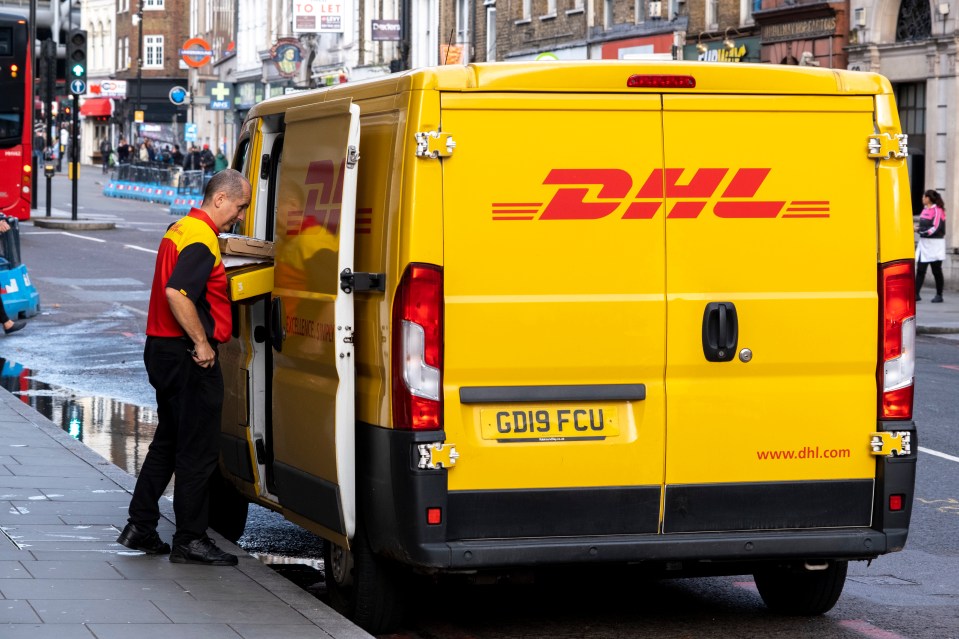 DHL delivery person unloading packages from a yellow van.
