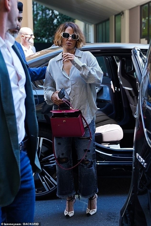 She teamed the classic look with black and white heels, while she toted a red Mortimer bag, worth a whopping £1.7k