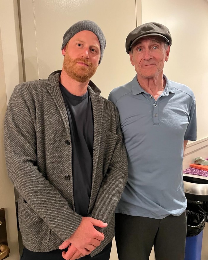 Prince Harry and James Taylor in a photo together.