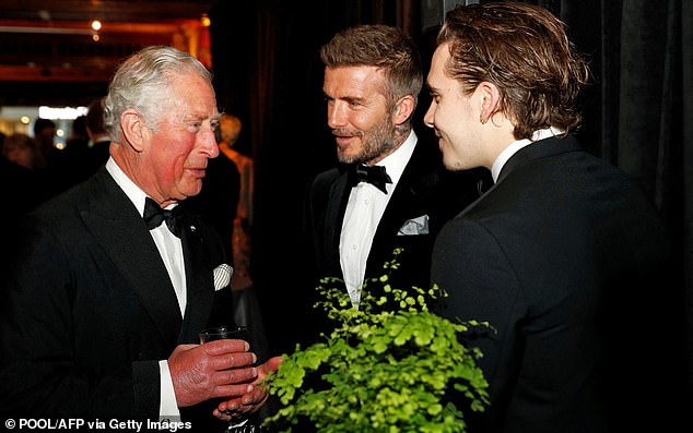 Brooklyn and David pictured with King Charles in 2019