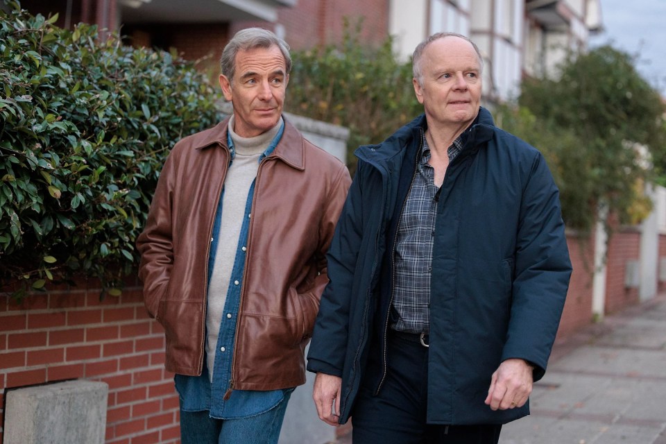 Two men walking down a street.