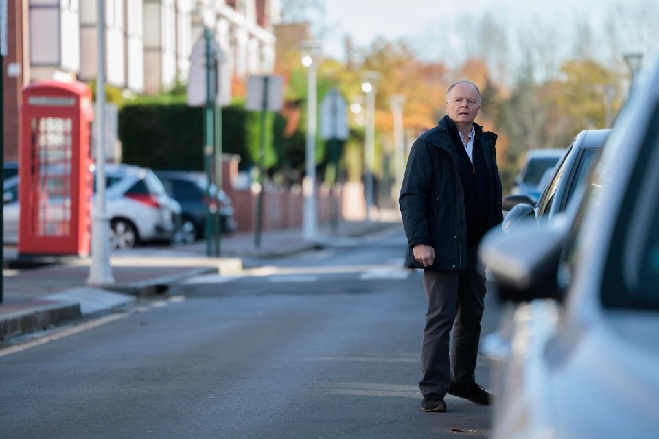 Man standing on a residential street.