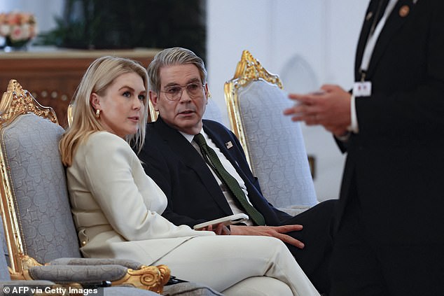White House press secretary Karoline Leavitt (left) wore a grey pantsuit to daytime meetings in Doha, Qatar on Wednesday