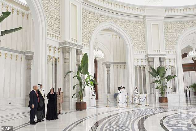 President Donald Trump speaks with Qatar's Emir Sheikh Tamim bin Hamad Al Thani prior a state dinner at the Lusail Palace in Doha Wednesday night