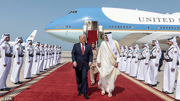 President Donald Trump walks alongside Qatar's Emir Sheikh Tamim bin Hamad al-Thani as he arrives in Doha, Qatar - the second stop in his three-country tour of the Middle East this week