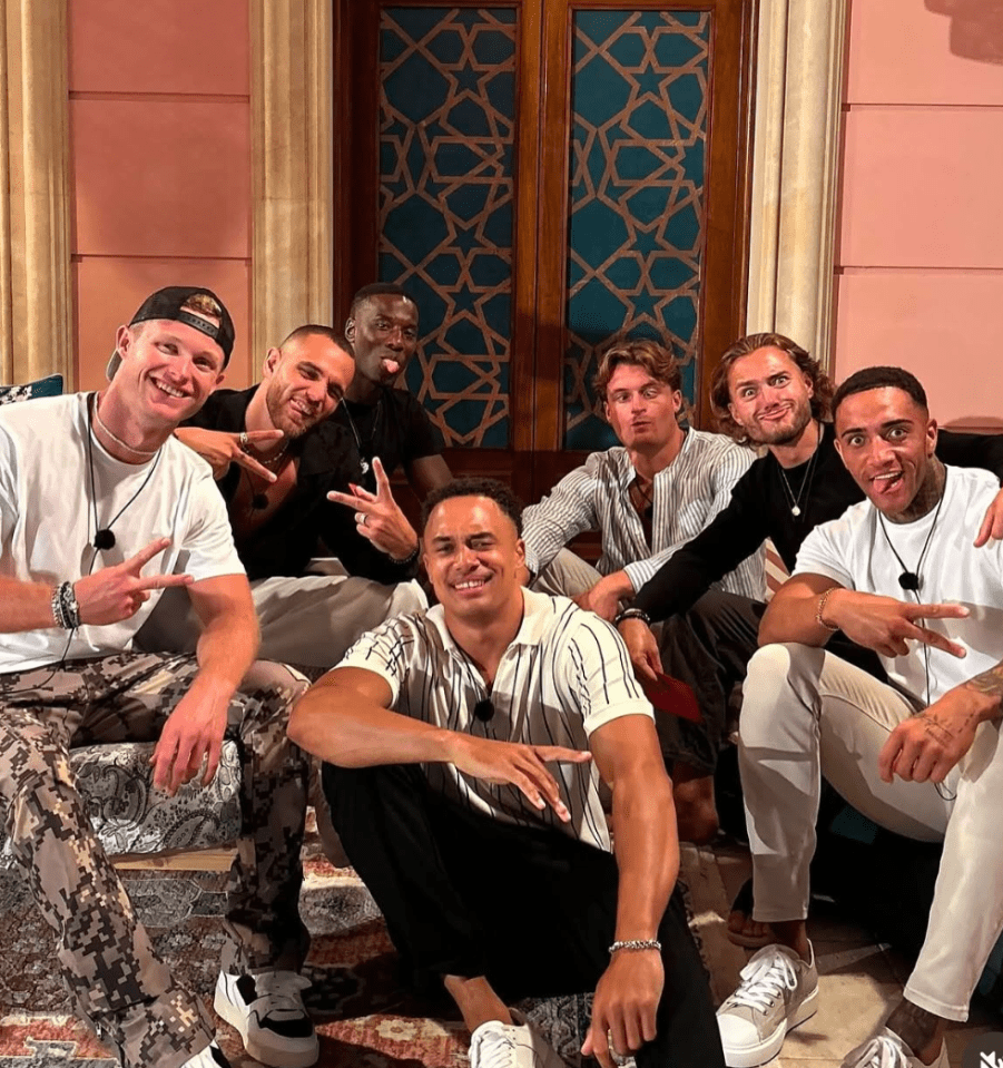 Group photo of seven men posing together.