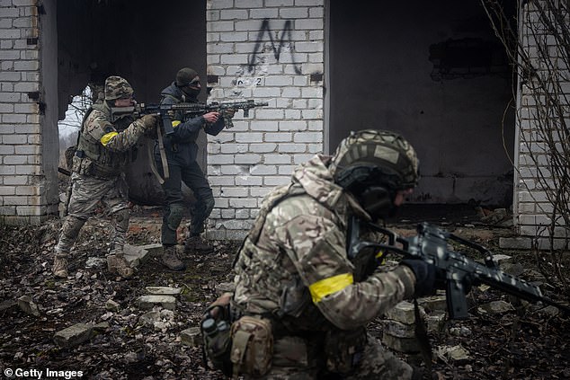 Civilians take part in a military training activity day conducted by the Ukrainian Volunteer Army
