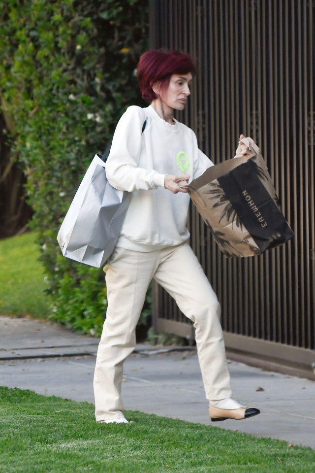 Sharon Osbourne carrying shopping bags.