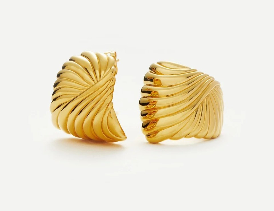 Pair of gold hoop earrings with ribbed texture.