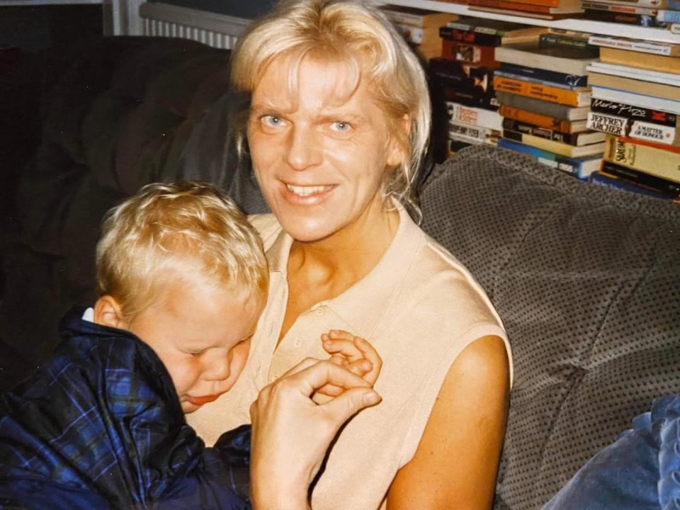 A woman holding a young boy.