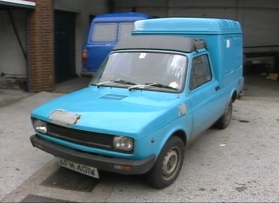 Light blue Fiat Fiorino van parked in a garage.