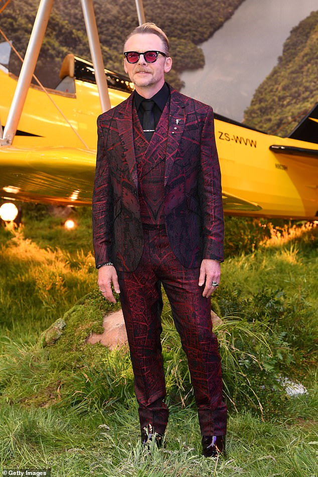 Tom was joined by his co-star and on-screen sidekick Simon Pegg, who made a bold statement in a vibrant red and black patterned suit and matching red sunglasses