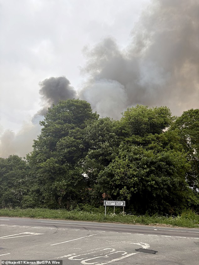 Witnesses have heard 'multiple explosions' and have seen clouds of smoke billowing for miles as an inferno engulfed a former RAF base