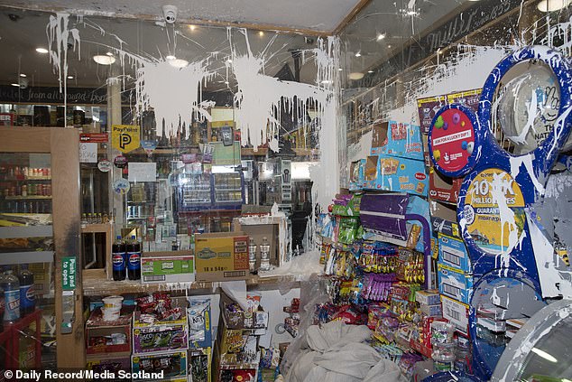 Pictured: the scene of vandalism, including white paint thrown by youngsters, in Mr Munir's shop. Speaking to MailOnline, he said that on Saturday, May 3, masked teenagers entered his shop, all allegedly under the influence of alcohol and drugs, and became 'out of control'