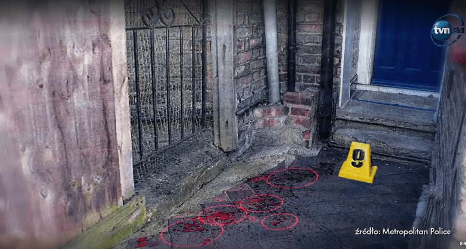 Crime scene photo showing blood splatter marked with red circles and a yellow evidence marker.