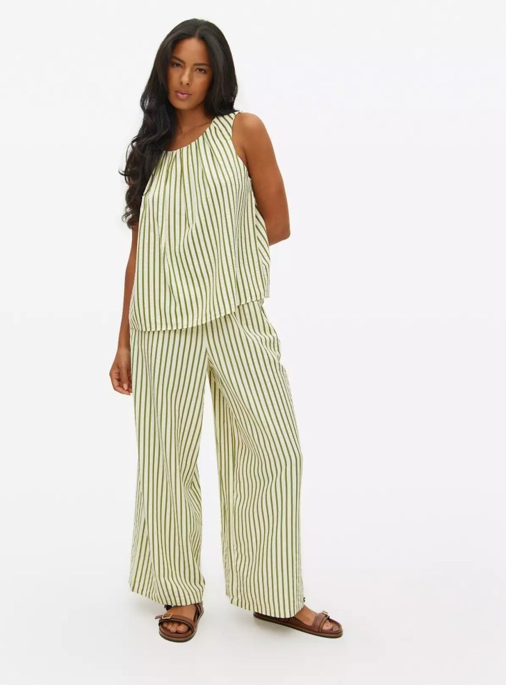 Woman in green and white striped pants and top.