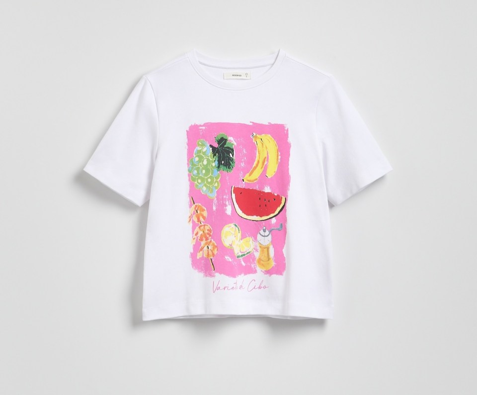 White t-shirt with fruit illustration.
