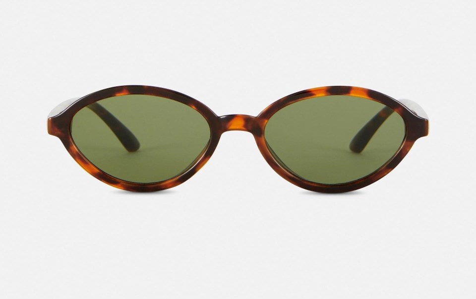 Oval tortoiseshell sunglasses with green lenses.