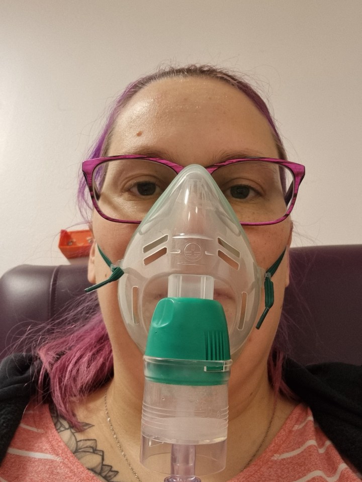 Woman using a nebulizer mask.