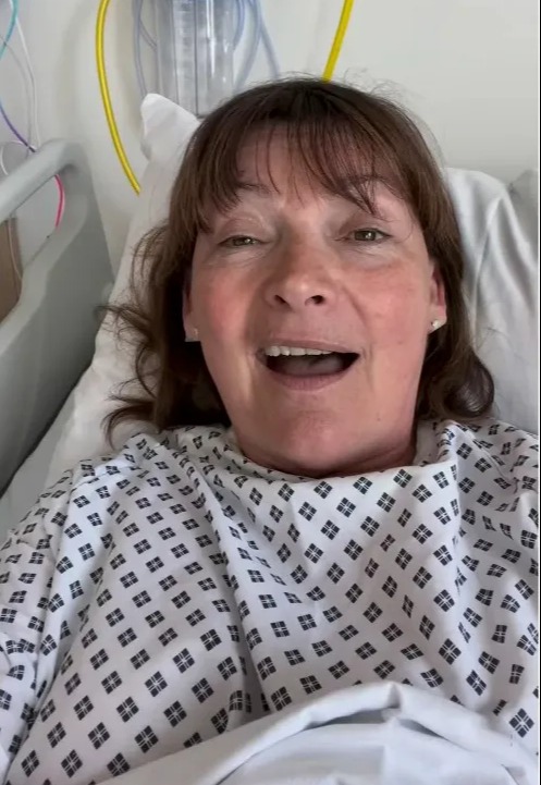 Lorraine Kelly in a hospital bed, speaking to the camera.
