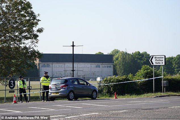 Police officers patrol at a cordon near the scene at Bicester Motion, the site of a former RAF base