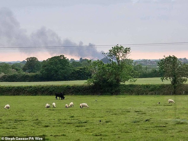 Smoke is seen rising from a fire where two firefighters and a member of the public have died
