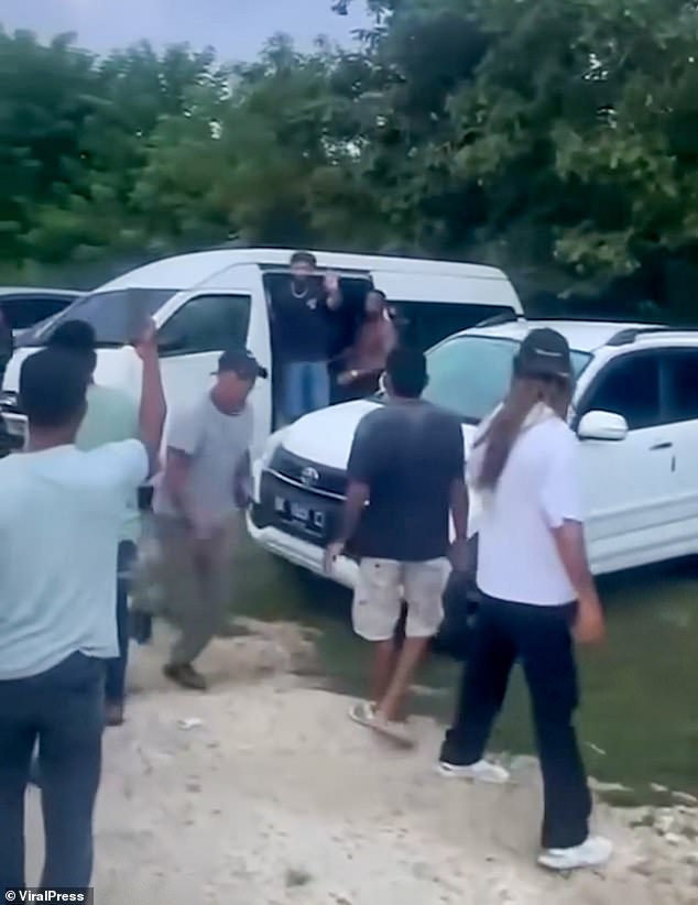 A voice was heard in the footage repeatedly saying: 'Don't damage the car'. Joseph is seen trying to shelter in the van from the mob