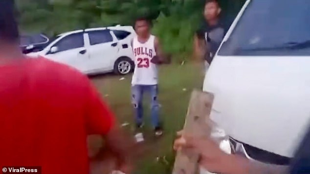 The mob was seen carrying wooden planks and reportedly hurled rocks