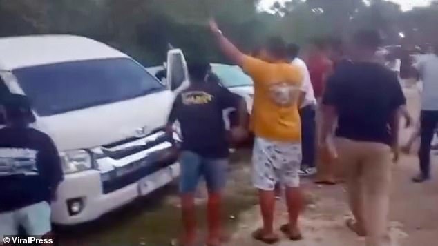 Crowds swarmed around the white van as the British holidaymaker hid inside