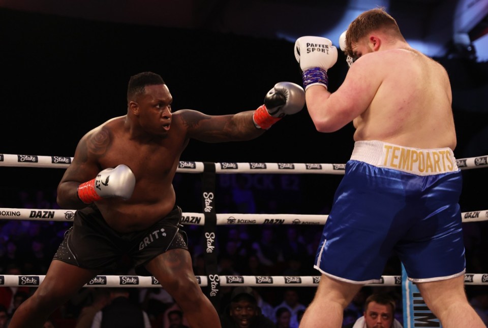 TELFORD, ENGLAND - MARCH 04: Godson Umeh punches Tempo Arts during the heavyweight match between Tempo Arts and Godson Umeh at Telford International Centre on March 04, 2023 in Telford, England. (Photo by Nathan Stirk/Getty Images)