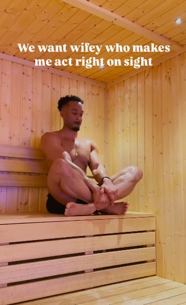 Man sitting cross-legged in a sauna.