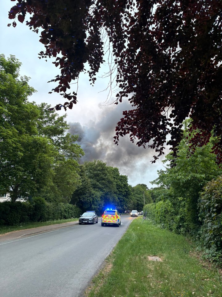 Police car near a large fire.