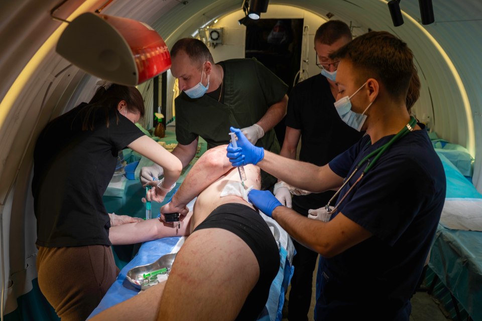 Medical personnel attending to a patient in a confined space.