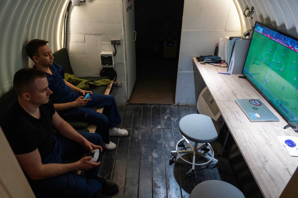 Two men playing video games in a bunker.