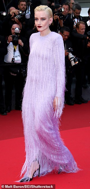 She complemented her look with a deep purple lipstick